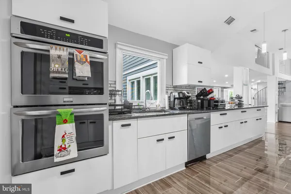 a kitchen with stainless steel appliances granite countertop a stove and a sink