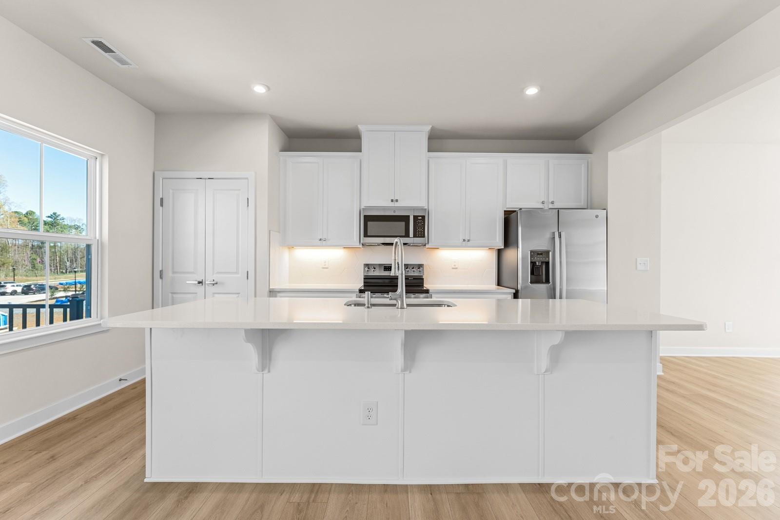 6012 Blue Rdg Oak Road Charlotte, NC 28273 - Photo 2 of 15 a kitchen with stainless steel appliances a refrigerator a stove a sink and white cabinets