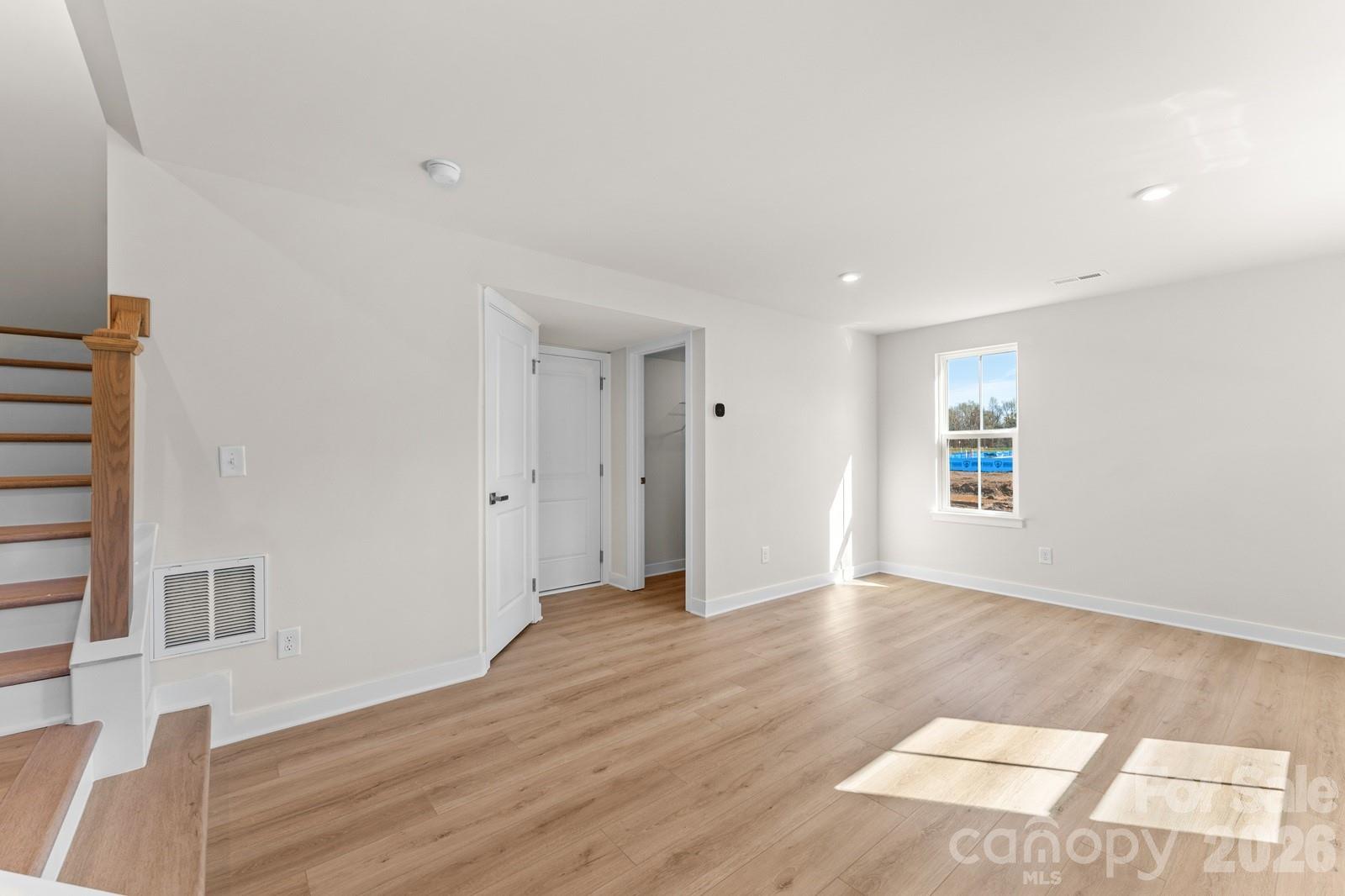 6012 Blue Rdg Oak Road Charlotte, NC 28273 - Photo 5 of 15 an empty room with wooden floor and windows
