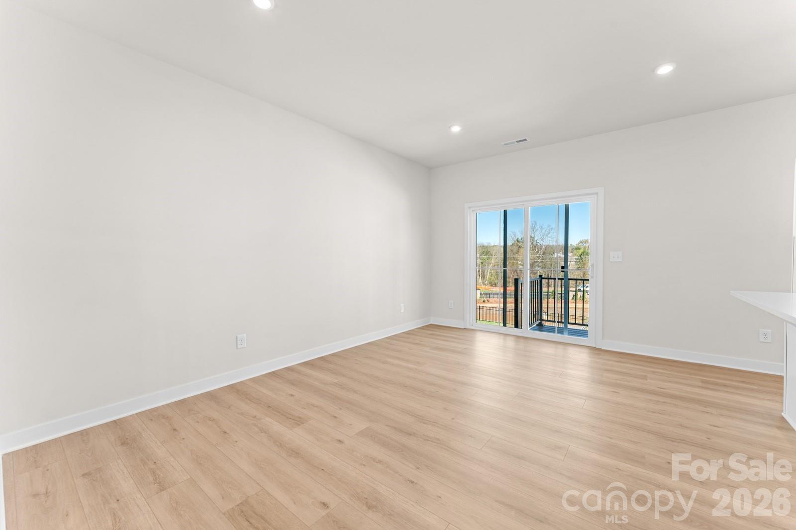 6012 Blue Rdg Oak Road Charlotte, NC 28273 - Photo 6 of 15 a view of an empty room with wooden floor and a window