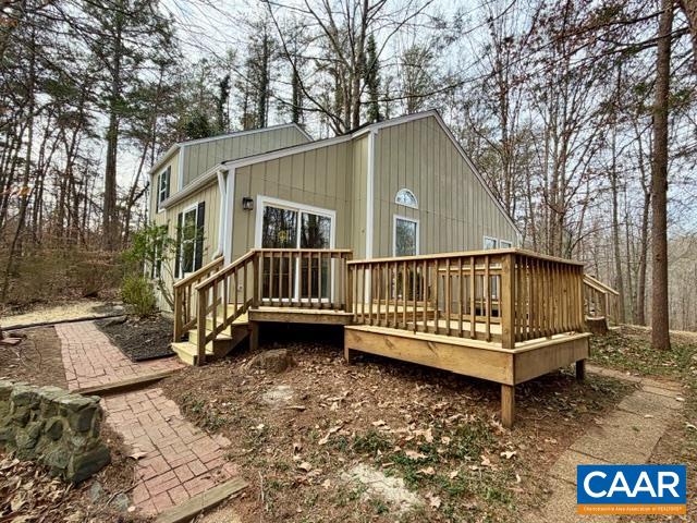 93 West Cedar Drive Ruckersville, VA 22968 - Photo 2 of 29 a view of a house with a wooden deck and a yard with large tree