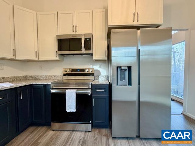93 West Cedar Drive Ruckersville, VA 22968 - Photo 6 of 29 a kitchen with stainless steel appliances granite countertop a refrigerator a stove a sink and dishwasher with wooden floor