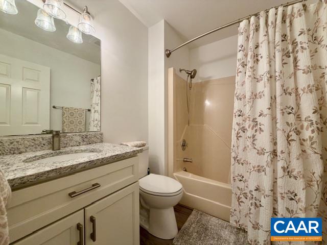 93 West Cedar Drive Ruckersville, VA 22968 - Photo 9 of 29 a bathroom with a granite countertop sink toilet a shower and a mirror