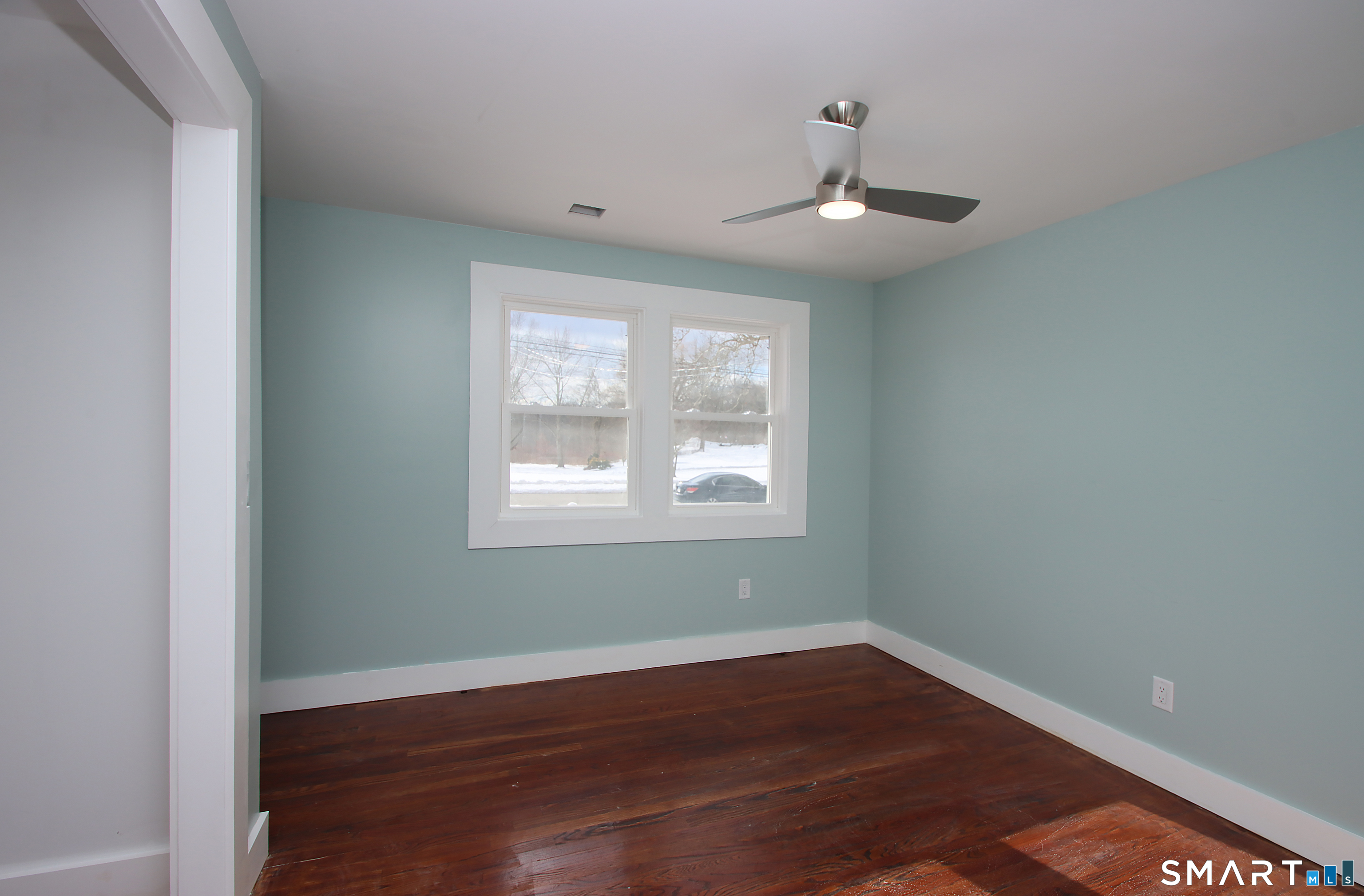 93 Overlook Road Meriden, CT 06450 - Photo 20 of 33 an empty room with wooden floor chandelier fan and windows
