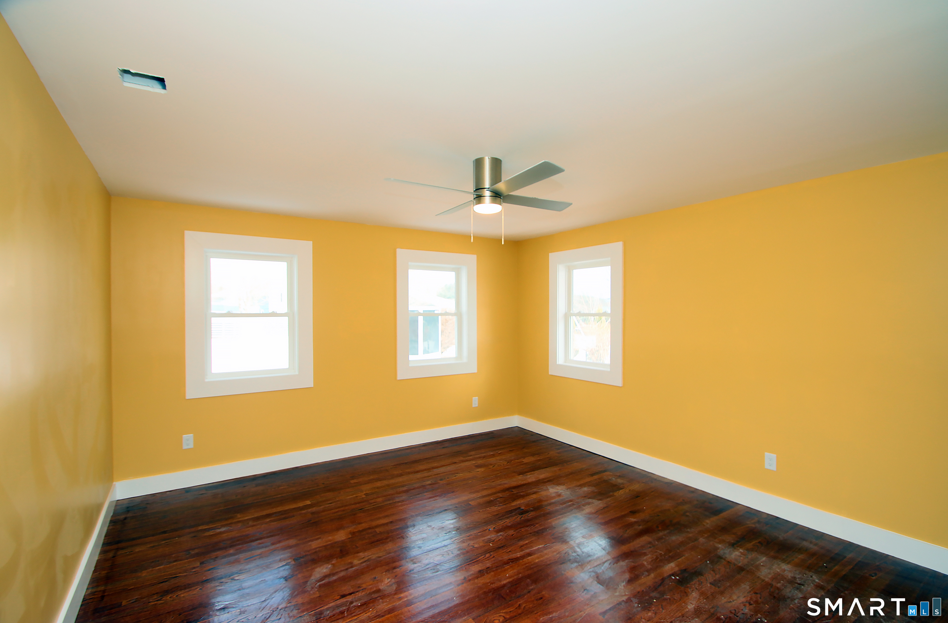 93 Overlook Road Meriden, CT 06450 - Photo 22 of 33 a view of an empty room with wooden floor and a window