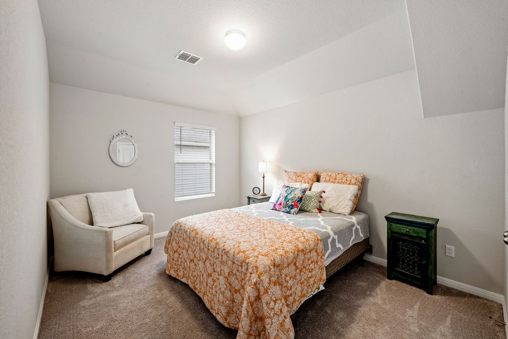 2417 Roosevelt Road Leander, TX 78641 - Photo 27 of 40 Bedroom featuring carpet flooring and lofted ceiling