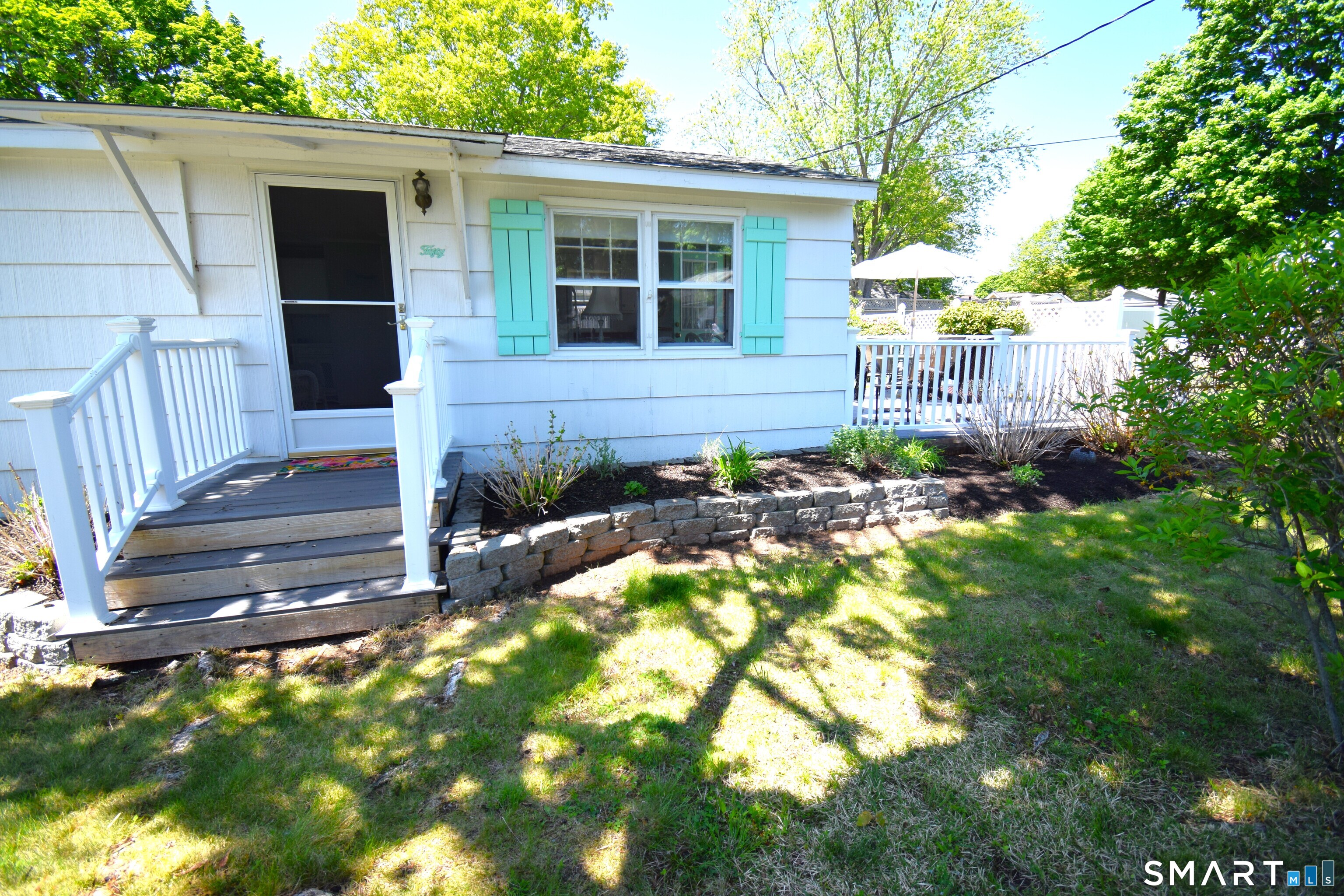 50 East Street Madison, CT 06443 - Photo 26 of 26 a view of a house with a small yard plants and large tree