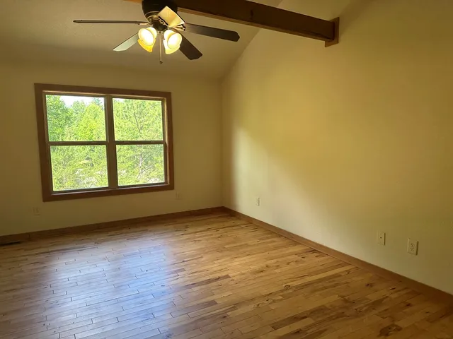 a bathroom with a granite countertop sink a bathtub and a mirror