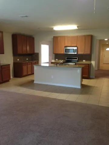 a view of kitchen with microwave and cabinets