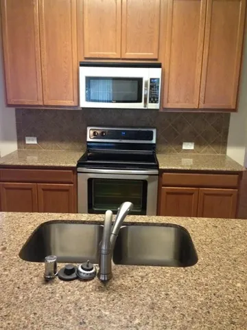 a kitchen with a sink and a microwave