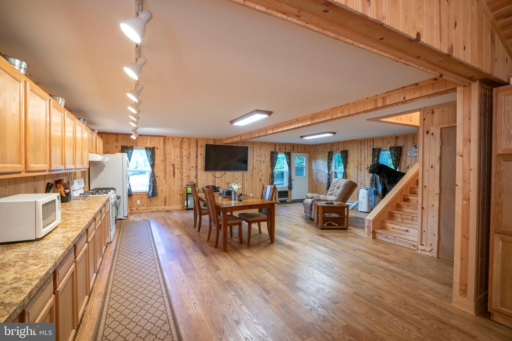 385 Elk Creek Road Aaronsburg, PA 16820 - Photo 25 of 71 a dining room with wooden floor and large windows
