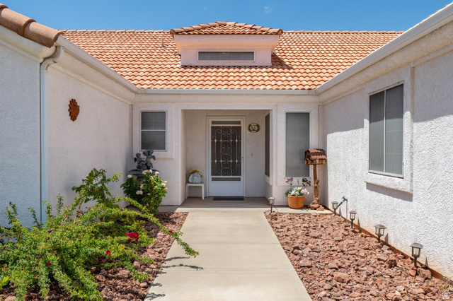 39 North Valley View Drive, Unit 51 St. George, UT 84770 - Photo 3 of 25 Entryway featuring a white stucco exterior, terracotta tile roof, and a concrete pathway