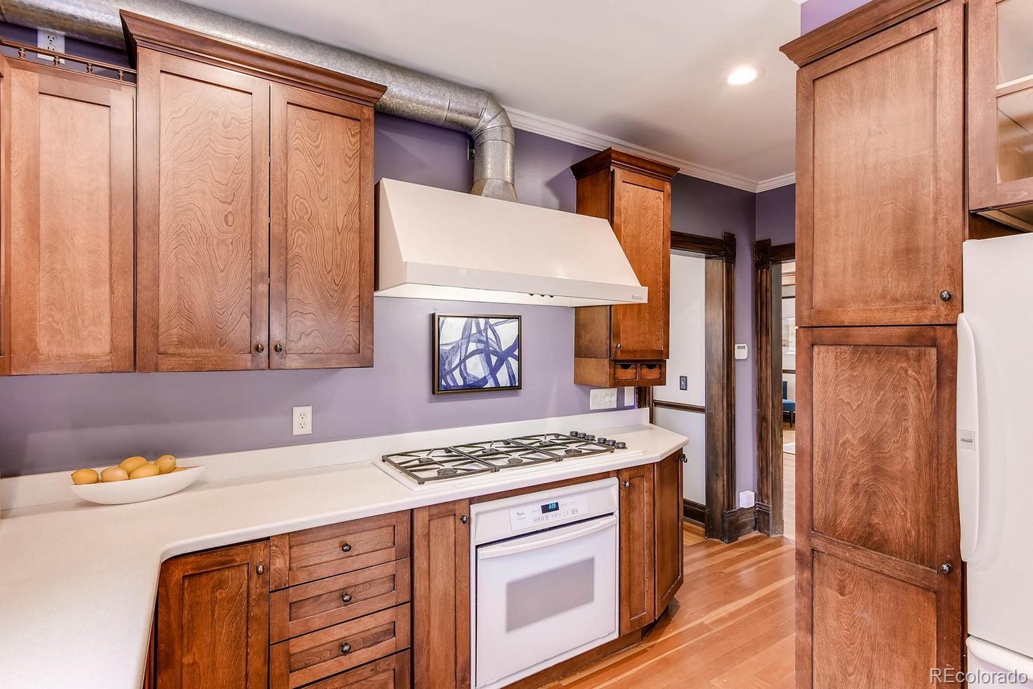 2030 Park Place Denver, CO 80205 - Photo 11 of 28 a kitchen with a stove and a refrigerator