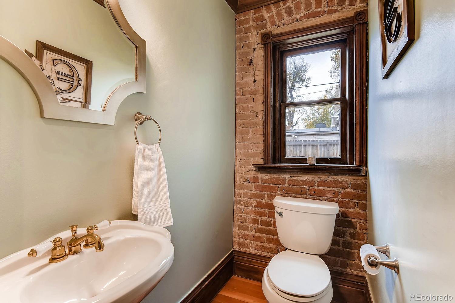 2030 Park Place Denver, CO 80205 - Photo 13 of 28 a bathroom with a toilet sink and mirror