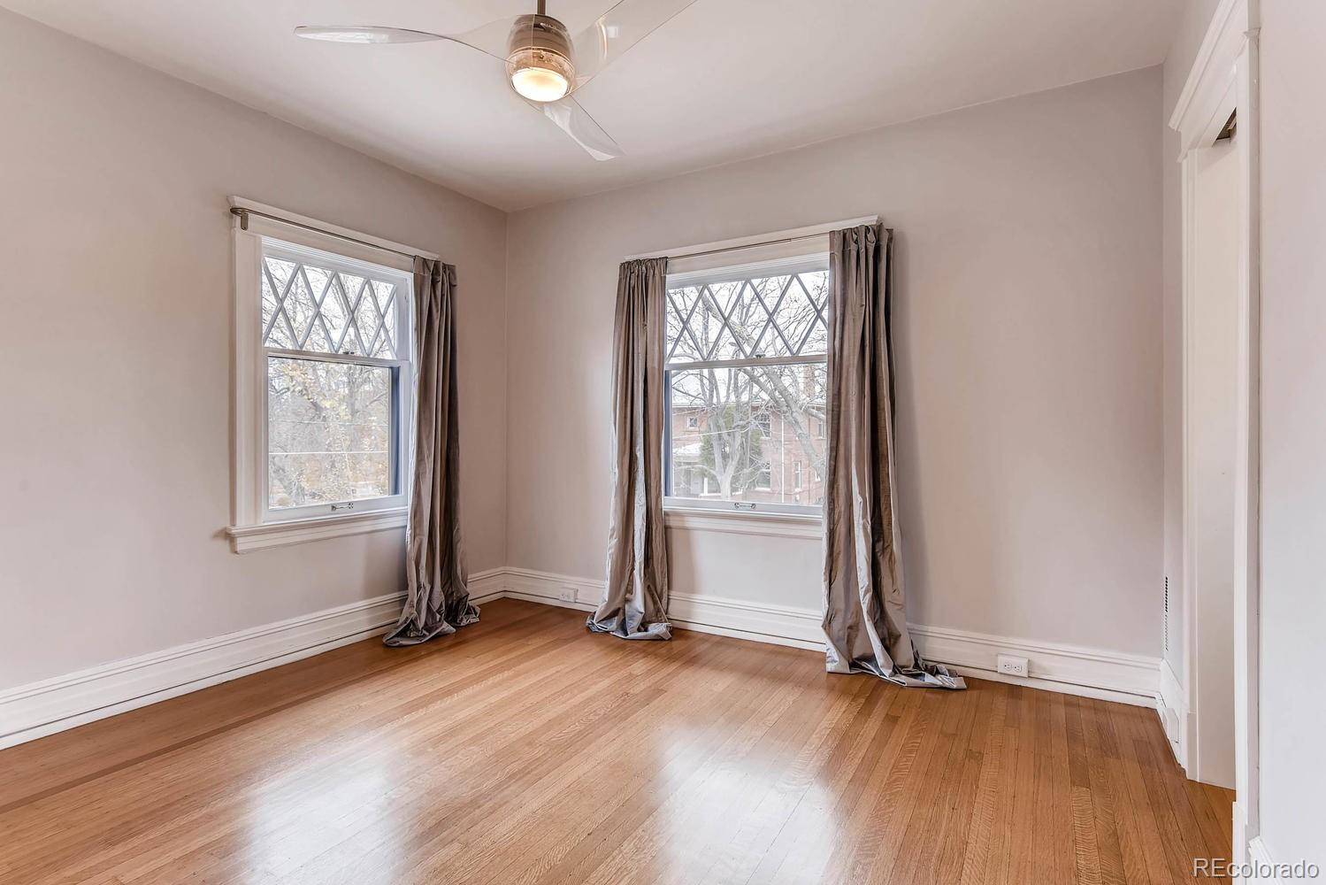 2030 Park Place Denver, CO 80205 - Photo 14 of 28 an empty room with wooden floor and windows