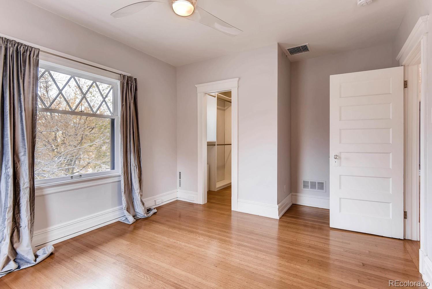 2030 Park Place Denver, CO 80205 - Photo 15 of 28 an empty room with wooden floor and windows