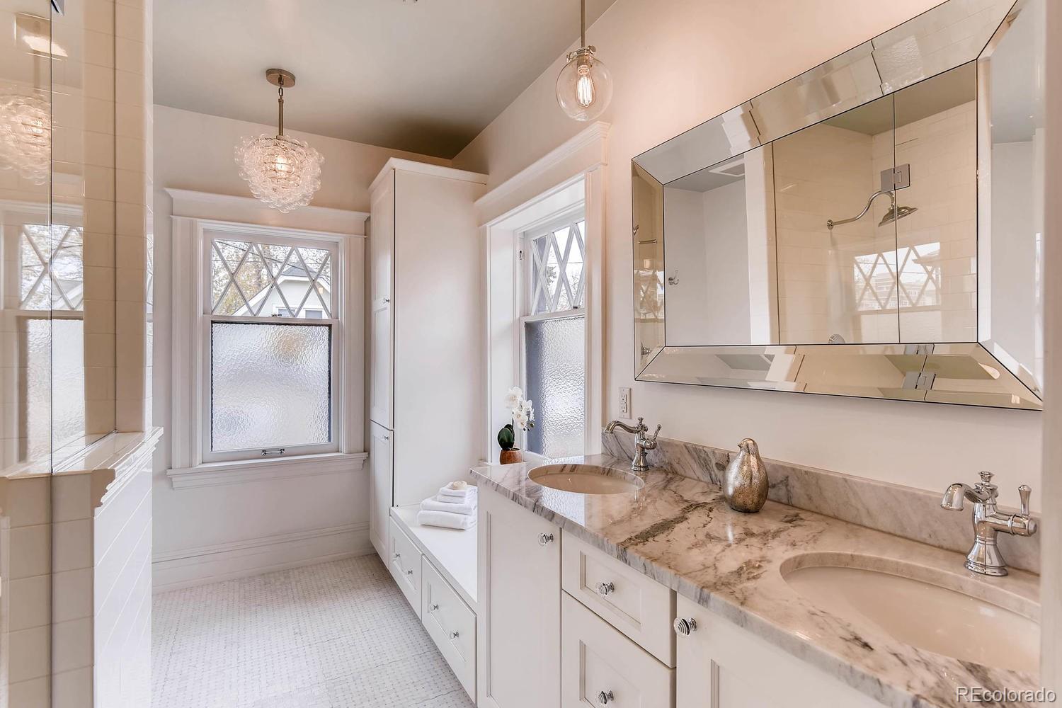 2030 Park Place Denver, CO 80205 - Photo 16 of 28 a bathroom with a granite countertop sink mirror and vanity