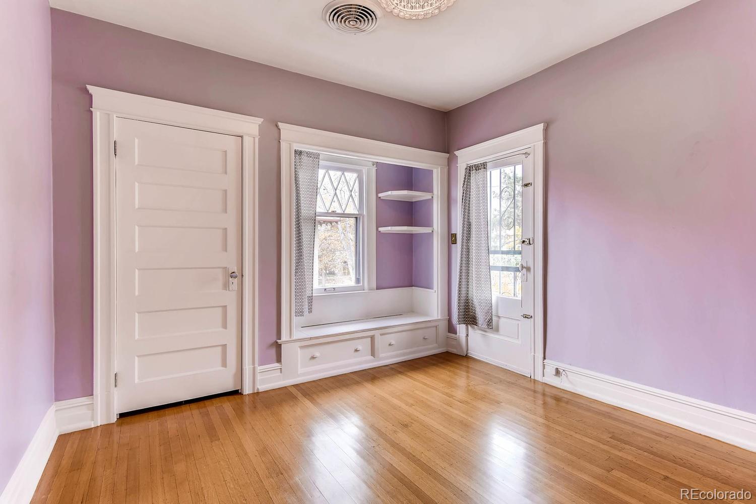 2030 Park Place Denver, CO 80205 - Photo 18 of 28 an empty room with wooden floor and windows