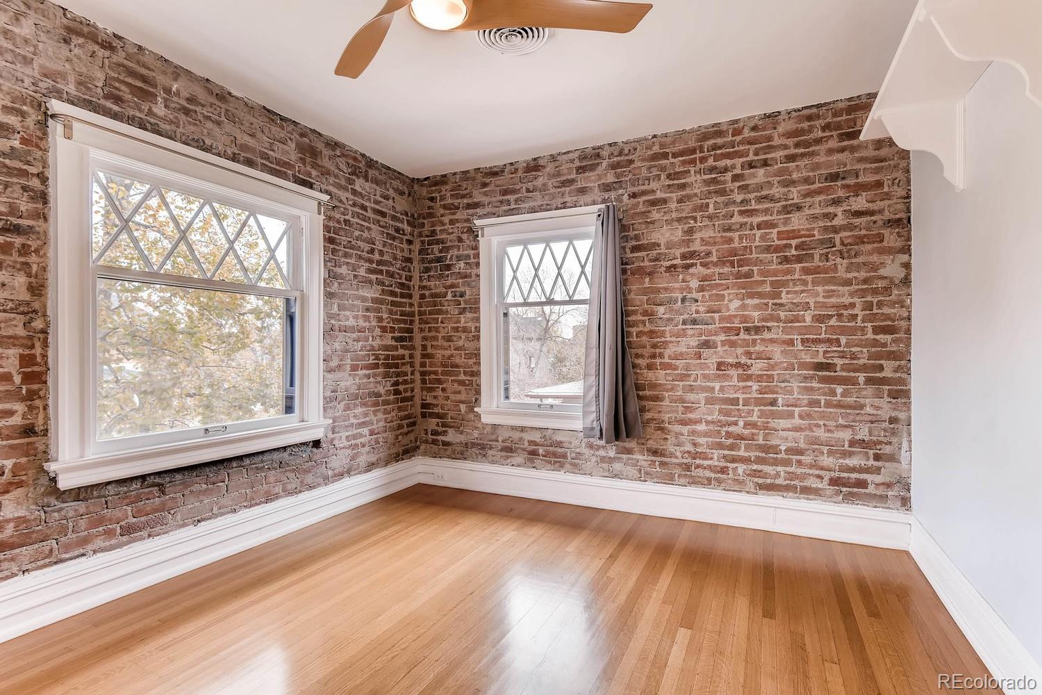 2030 Park Place Denver, CO 80205 - Photo 19 of 28 a view of an empty room with wooden floor and a window