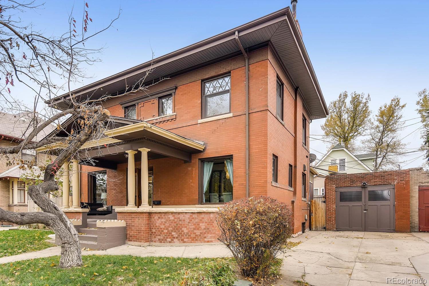 2030 Park Place Denver, CO 80205 - Photo 2 of 28 a front view of a house with garden