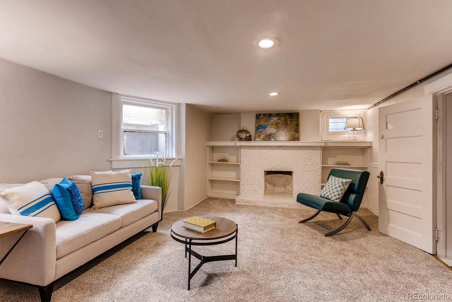 2030 Park Place Denver, CO 80205 - Photo 21 of 28 a living room with furniture and a fireplace