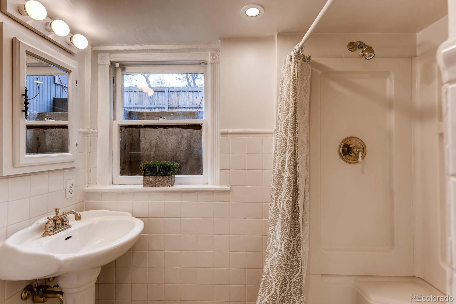 2030 Park Place Denver, CO 80205 - Photo 23 of 28 a bathroom with a sink a shower and a mirror