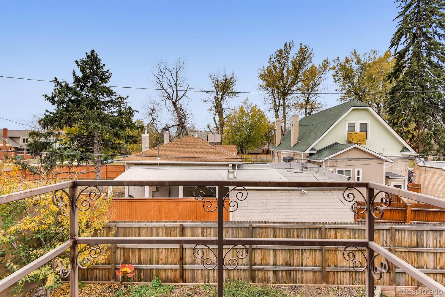2030 Park Place Denver, CO 80205 - Photo 25 of 28 a front view of a house with a yard and garage