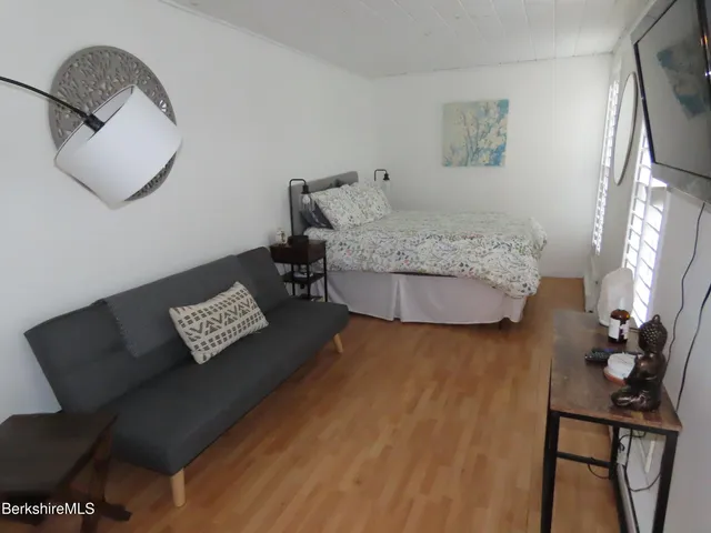 a living room with furniture and a mirror