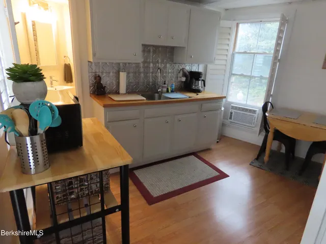 a kitchen with sink cabinets and wooden floor