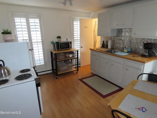 a kitchen with sink refrigerator and window