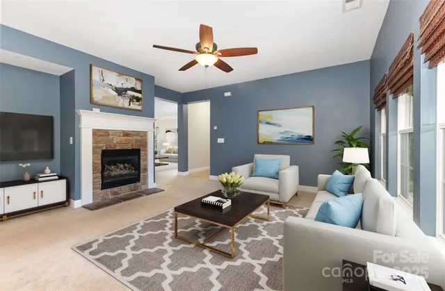 a living room with furniture a fireplace and a flat screen tv