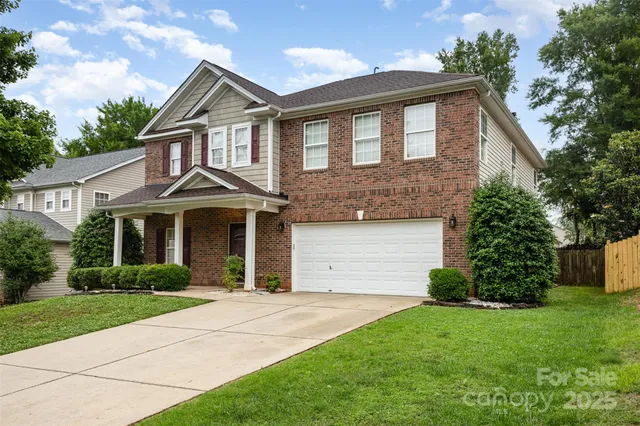 a front view of a house with a garden and plants