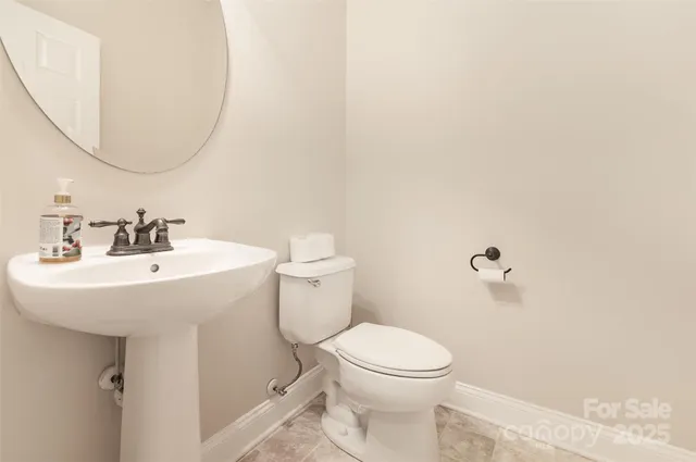 a bathroom with a sink a toilet and mirror