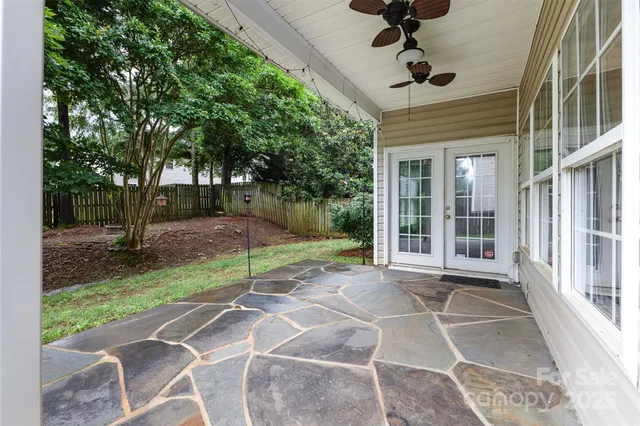 a view of a house with backyard and trees