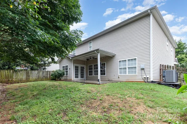 a front view of a house with a yard and lake view