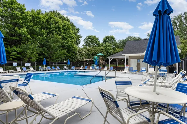 a view of a patio with swimming pool table and chairs
