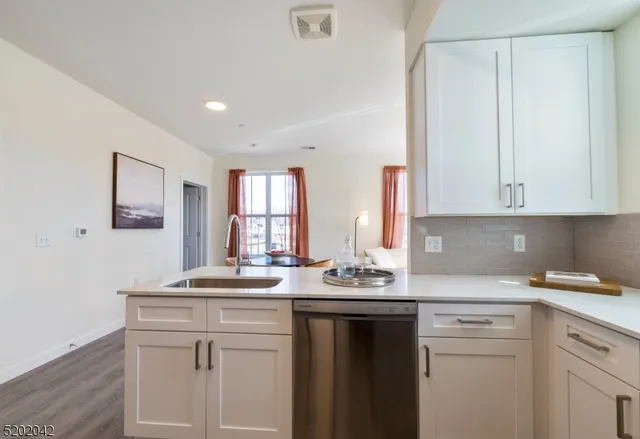 a kitchen with a sink cabinets and window