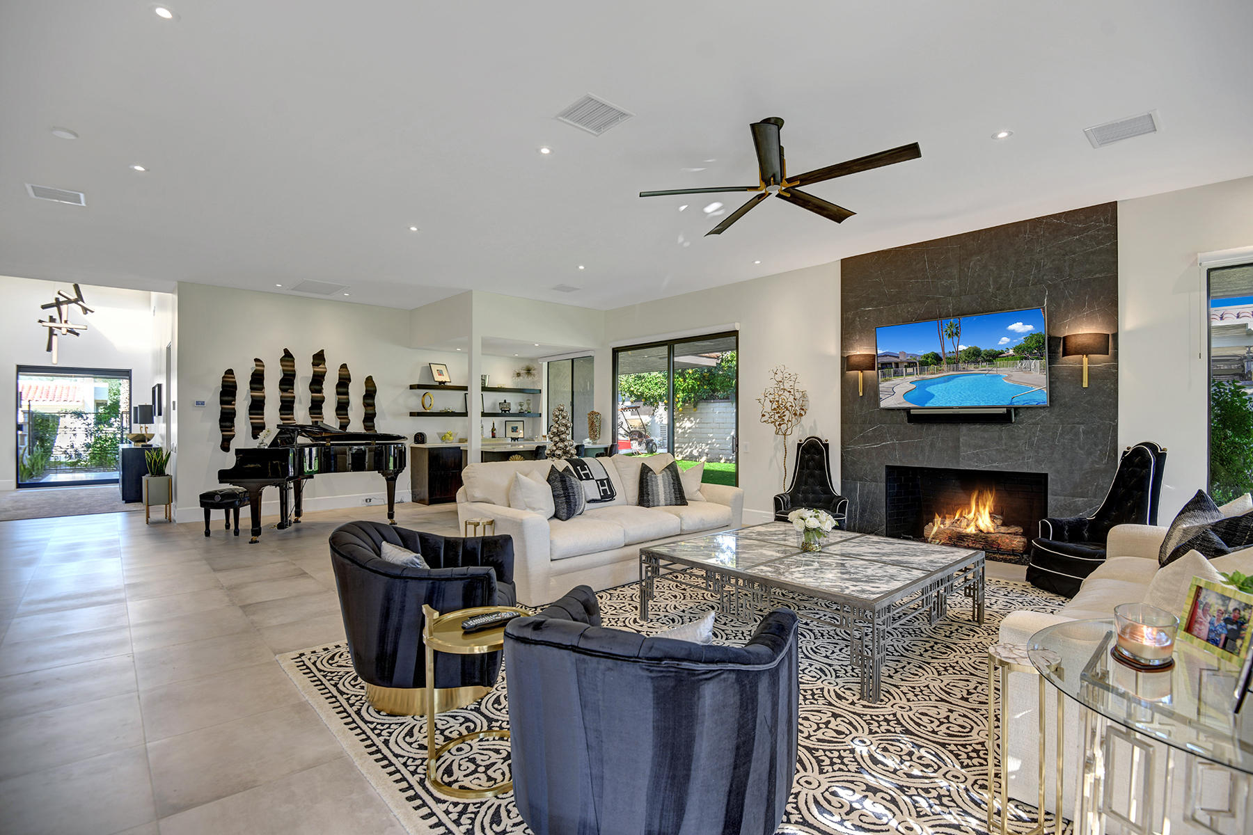 13 Rutgers Court Rancho Mirage, CA 92270 - Photo 11 of 42 a living room with furniture a fireplace and a flat screen tv