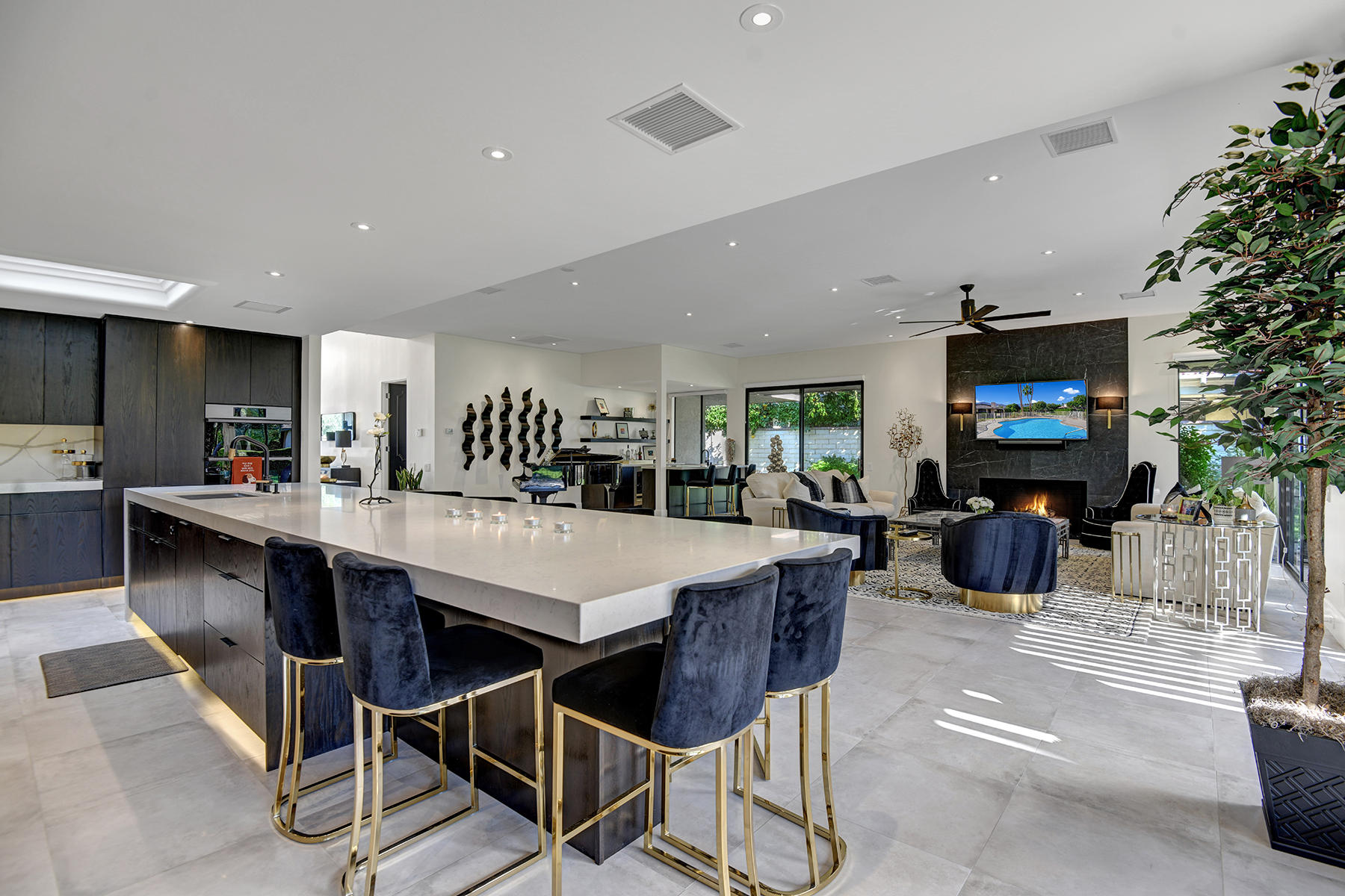 13 Rutgers Court Rancho Mirage, CA 92270 - Photo 13 of 42 a kitchen with stainless steel appliances kitchen island granite countertop a dining table chairs and a refrigerator