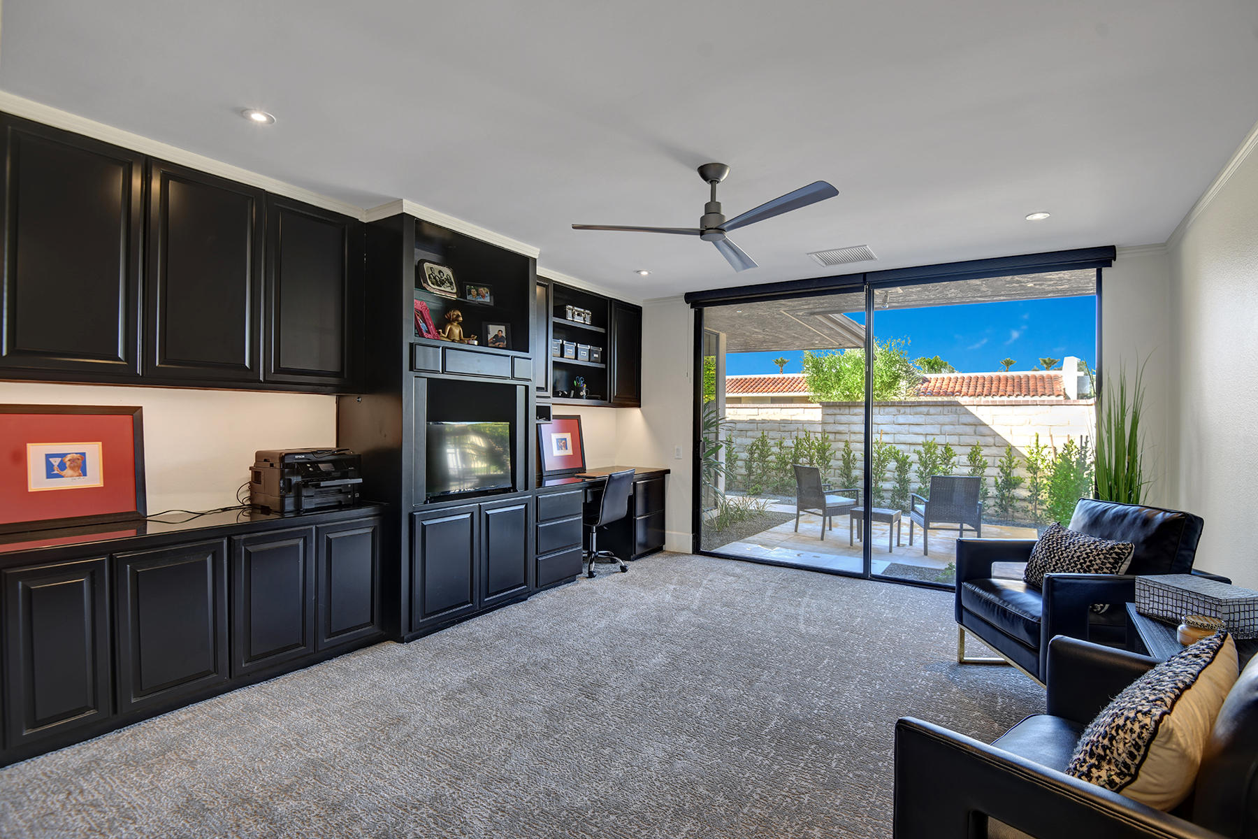 13 Rutgers Court Rancho Mirage, CA 92270 - Photo 20 of 42 a living room with furniture a flat screen tv and floor to ceiling window