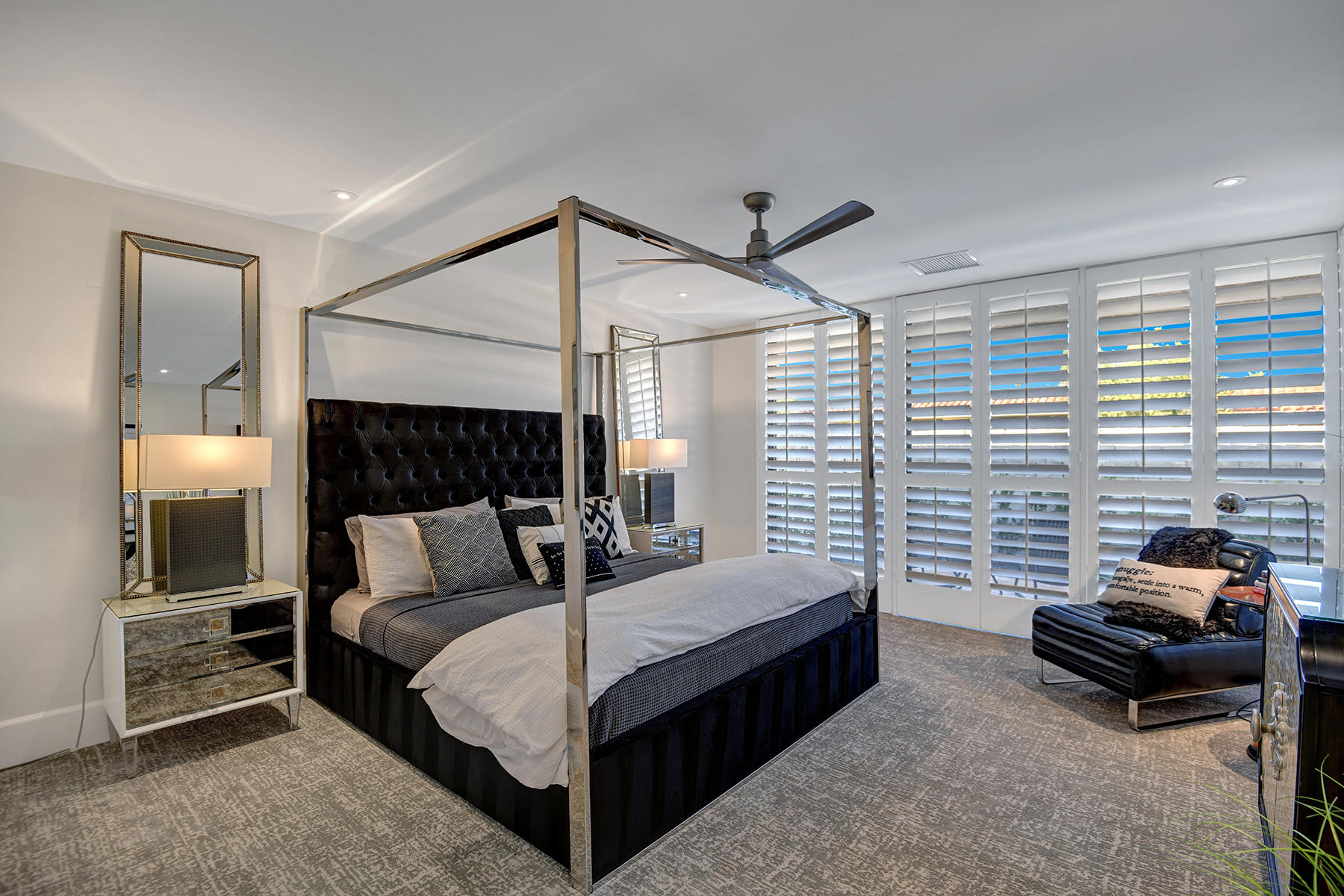 13 Rutgers Court Rancho Mirage, CA 92270 - Photo 22 of 42 a bedroom with a bed and a chandelier