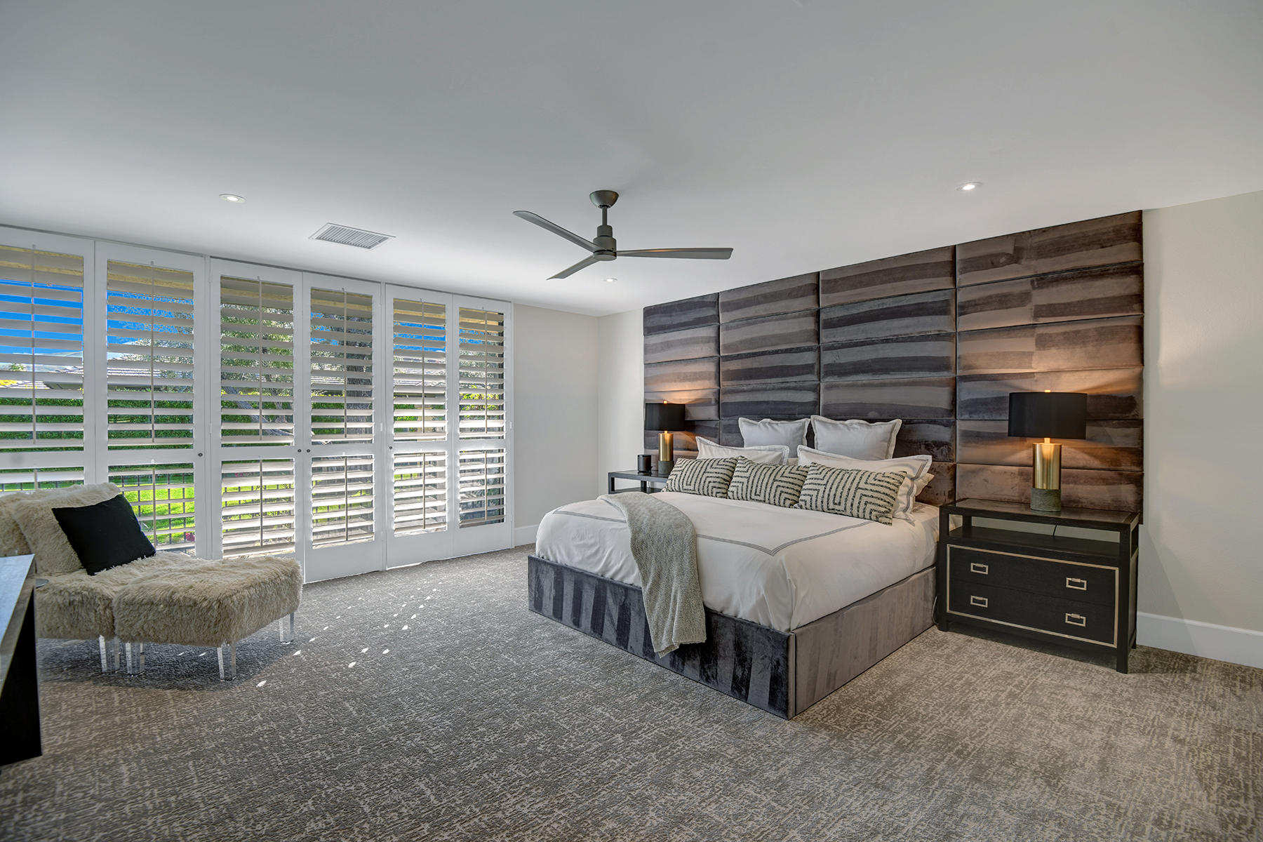 13 Rutgers Court Rancho Mirage, CA 92270 - Photo 27 of 42 a spacious bedroom with a bed and a couch