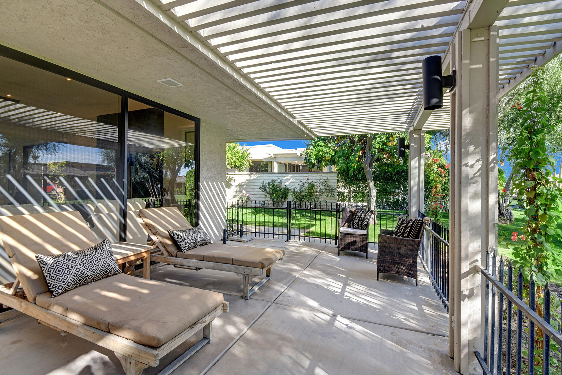 13 Rutgers Court Rancho Mirage, CA 92270 - Photo 36 of 42 a view of a patio with chairs and tables in the backyard