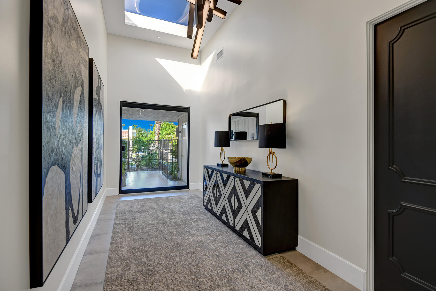 13 Rutgers Court Rancho Mirage, CA 92270 - Photo 5 of 42 a view of a hallway with a flat screen tv