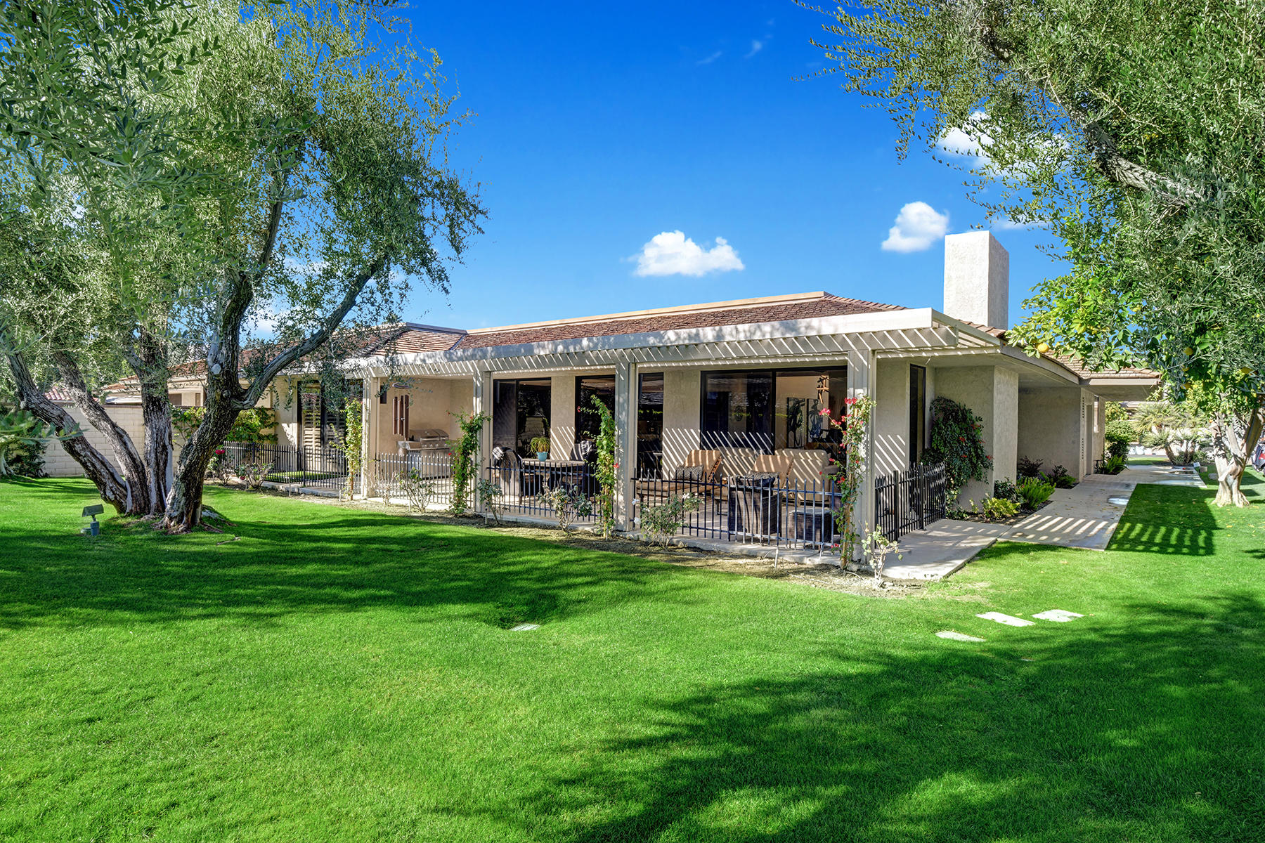 13 Rutgers Court Rancho Mirage, CA 92270 - Photo 41 of 42 a front view of a house with backyard and sitting area