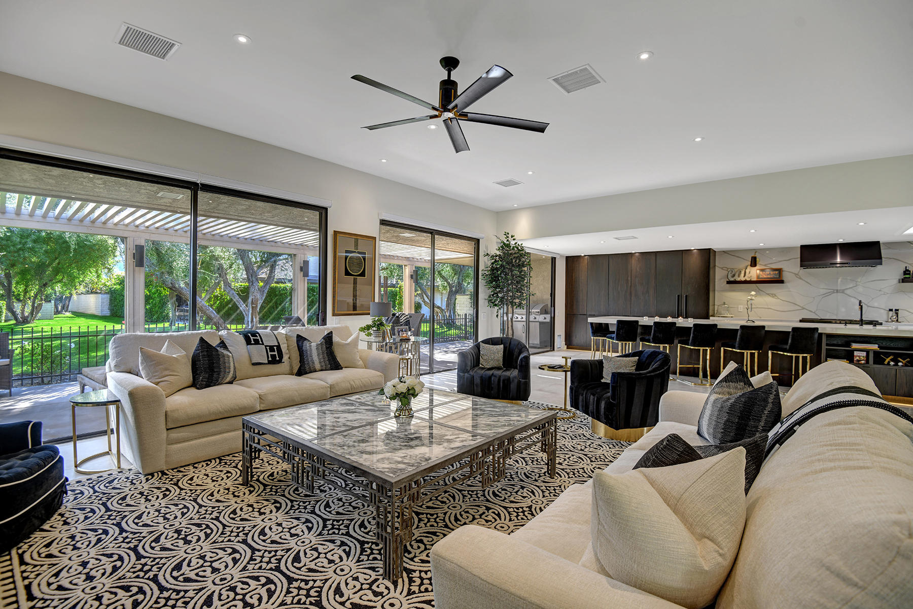 13 Rutgers Court Rancho Mirage, CA 92270 - Photo 8 of 42 a living room with furniture a ceiling fan and a large window