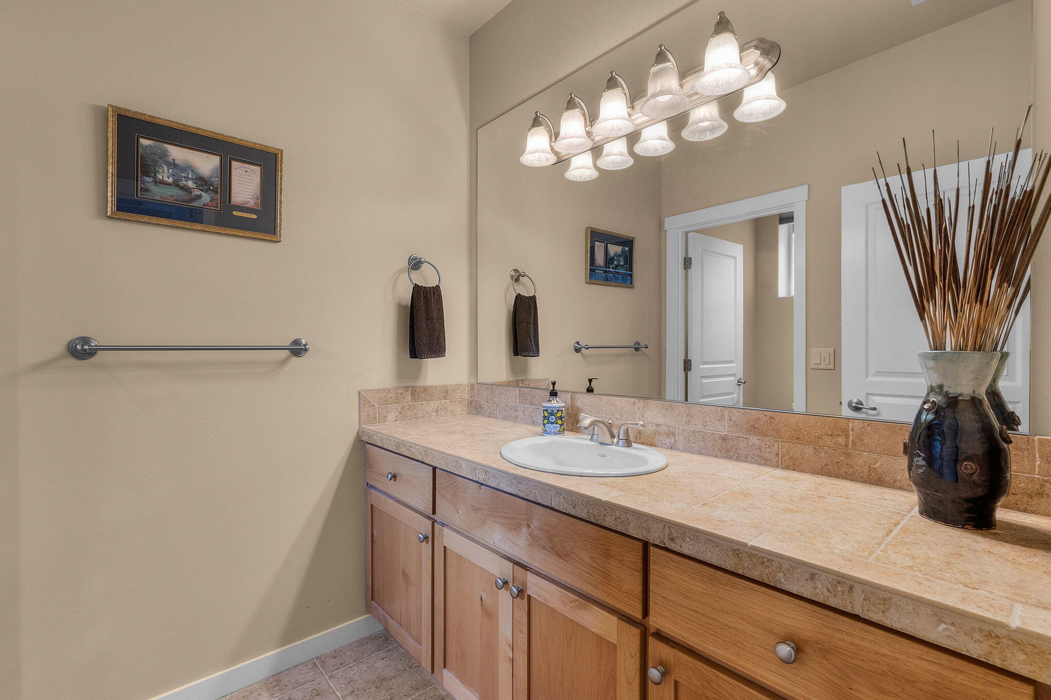 10870 Village Loop Redmond, OR 97756 - Photo 22 of 35 a bathroom with a sink a large mirror and a shower