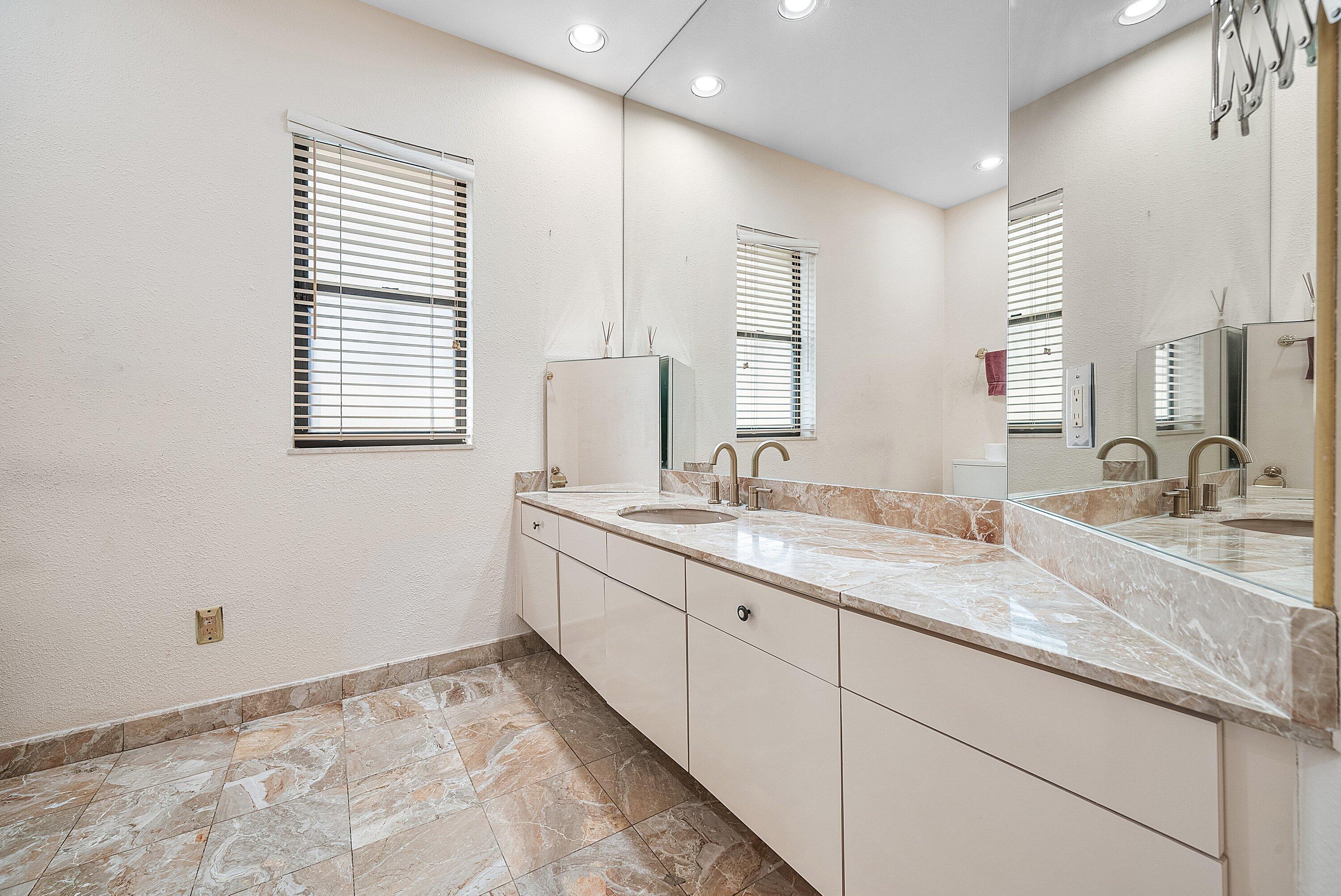 4952 Bocaire Boulevard Boca Raton, FL 33487 - Photo 11 of 61 a bathroom with double sink and a mirror