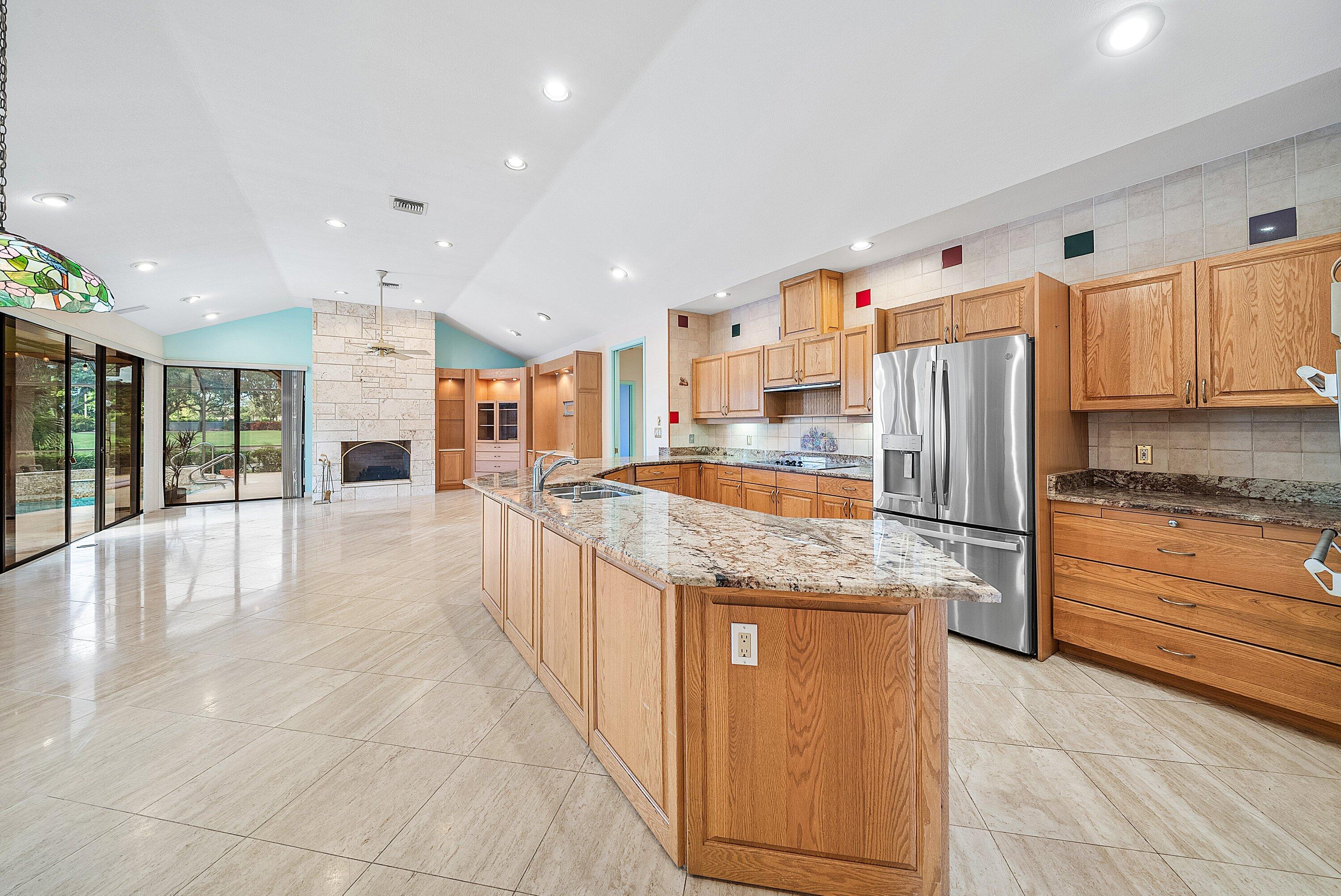 4952 Bocaire Boulevard Boca Raton, FL 33487 - Photo 13 of 61 a kitchen with stainless steel appliances granite countertop a refrigerator and a stove