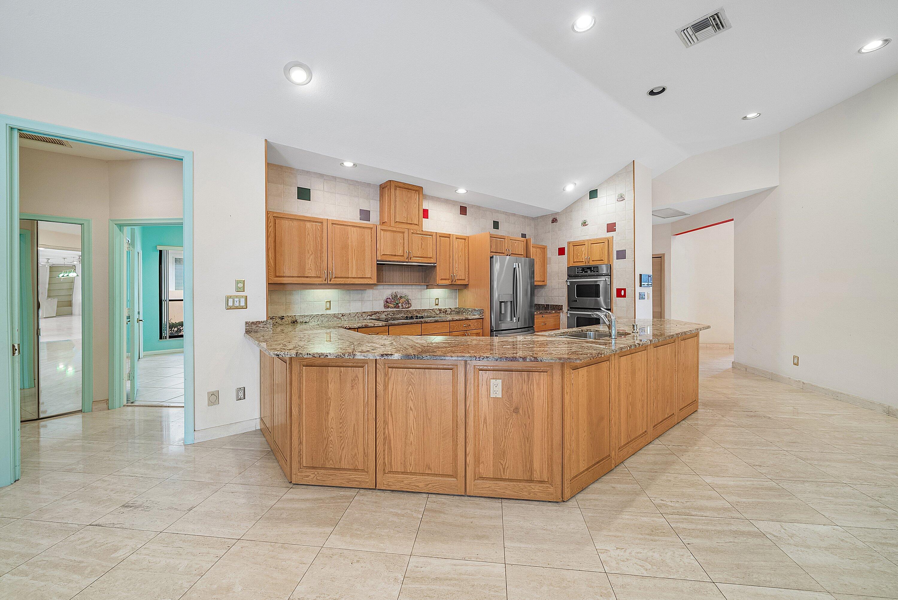 4952 Bocaire Boulevard Boca Raton, FL 33487 - Photo 14 of 61 a kitchen with stainless steel appliances a sink and cabinets